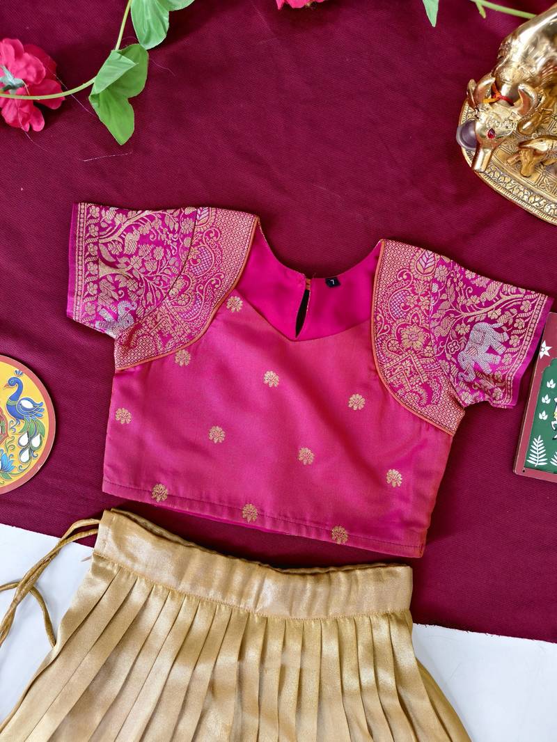 Gold silk tissue skirt paired with a soft silk top, adorned with a contrast pink border