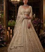 Beige net heavily embroidered bridal reception lehenga choli set