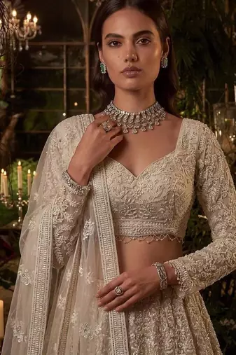 Beige net heavily embroidered bridal reception lehenga choli set