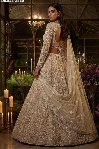 Beige net heavily embroidered bridal reception lehenga choli set