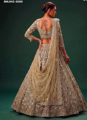 Beige net heavily embroidered royal bridal reception lehenga choli set 2