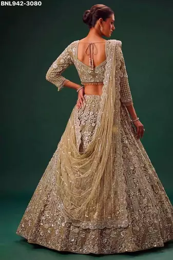 Beige net heavily embroidered royal bridal reception lehenga choli set