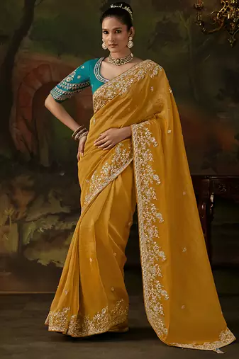 mustard yellow faux tissue saree with contrast embroidered blouse