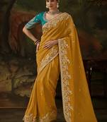mustard yellow faux tissue saree with contrast embroidered blouse