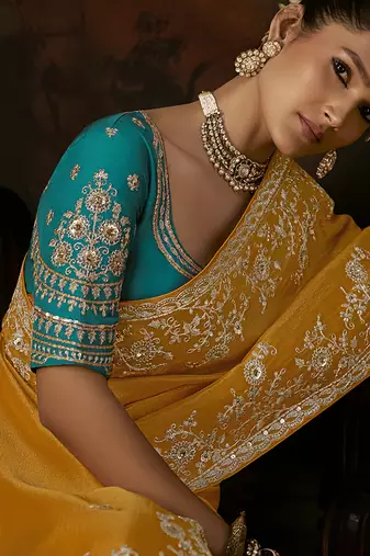 mustard yellow faux tissue saree with contrast embroidered blouse