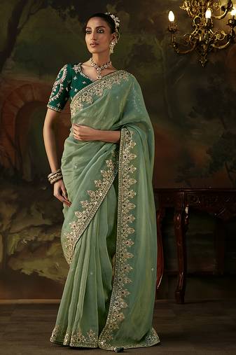 pista green faux tissue saree with contrast embroidered blouse