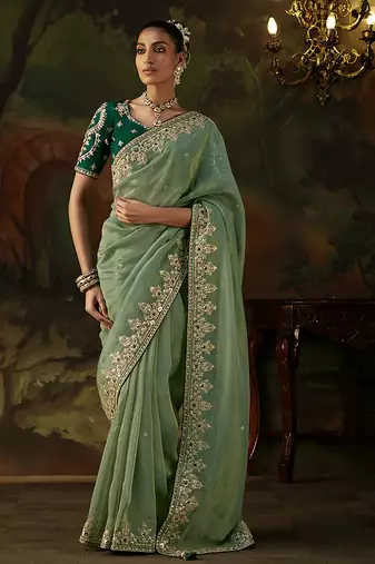 pista green faux tissue saree with contrast embroidered blouse