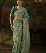 pista green faux tissue saree with contrast embroidered blouse