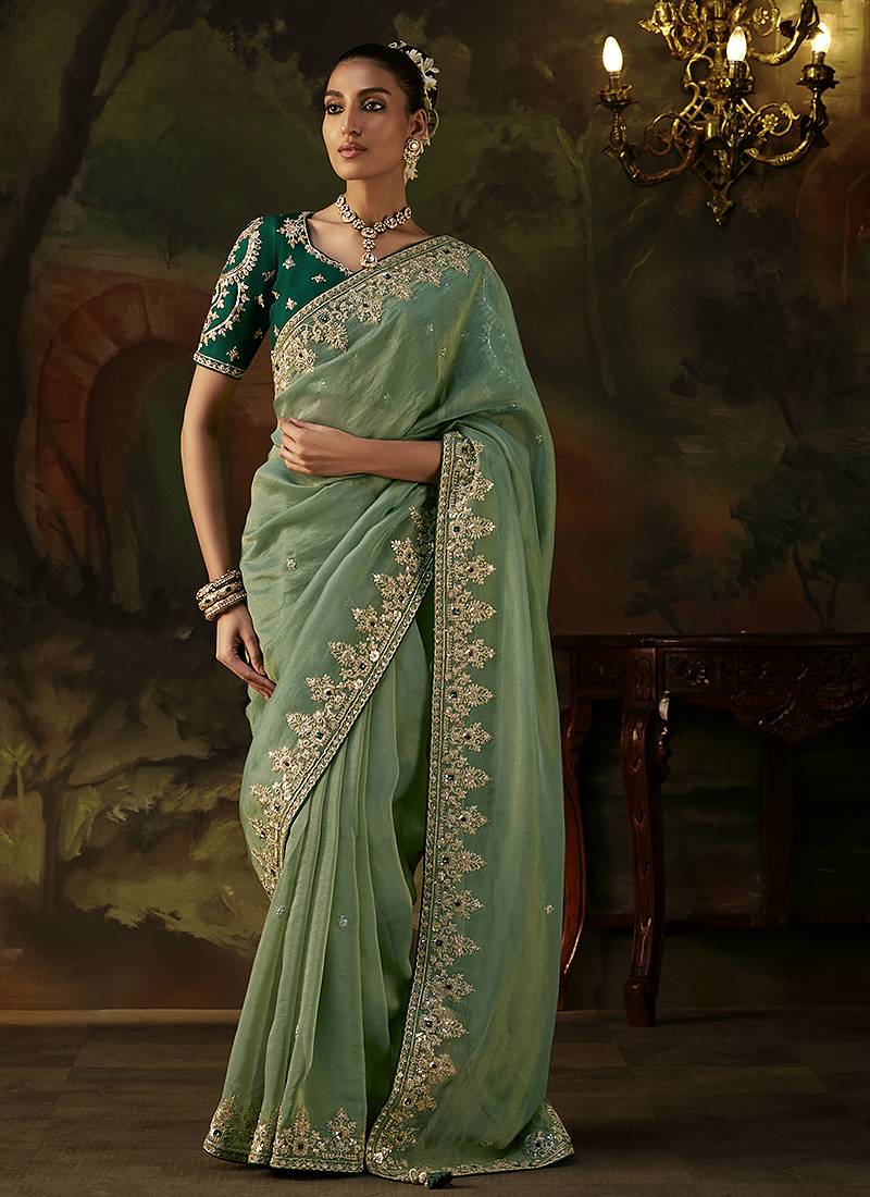 pista green faux tissue saree with contrast embroidered blouse