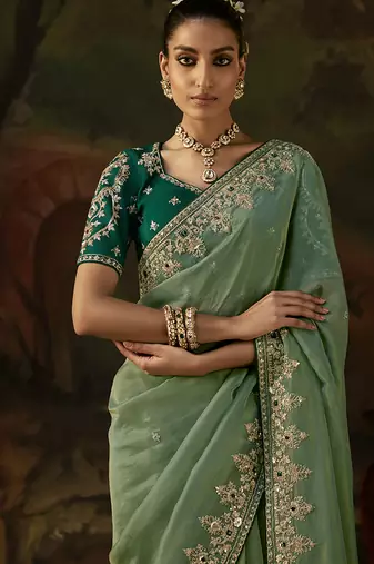 pista green faux tissue saree with contrast embroidered blouse