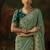 pista green faux tissue saree with contrast embroidered blouse