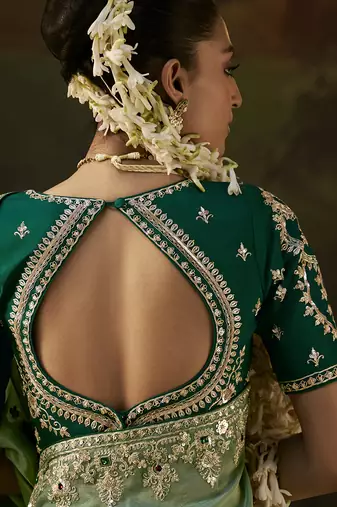 pista green faux tissue saree with contrast embroidered blouse