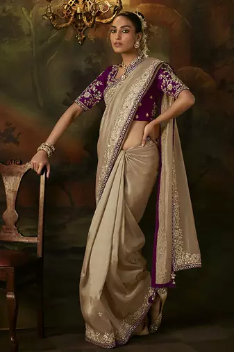 beige faux tissue saree with contrast embroidered blouse