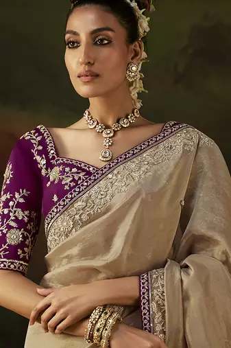 beige faux tissue saree with contrast embroidered blouse