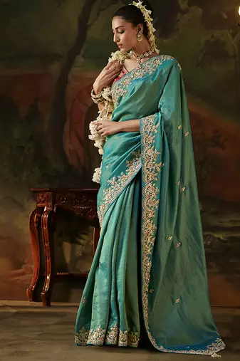 sea green faux tissue saree with contrast embroidered blouse