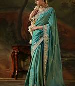 sea green faux tissue saree with contrast embroidered blouse
