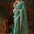 sea green faux tissue saree with contrast embroidered blouse