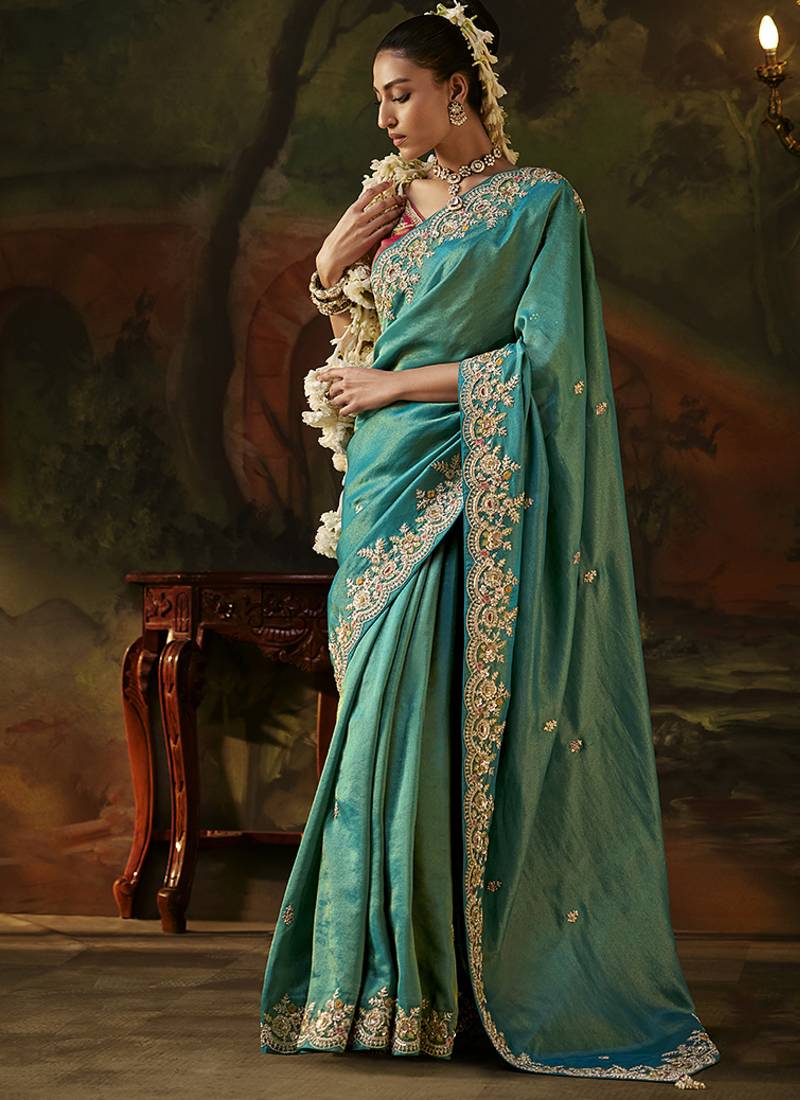 sea green faux tissue saree with contrast embroidered blouse
