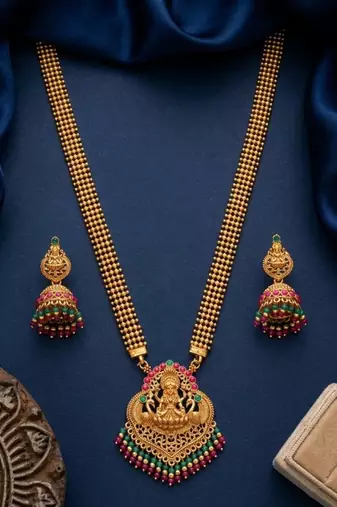 gold temple jewelry set with goddess lakshmi pendant, green & red beads & jhumkas 