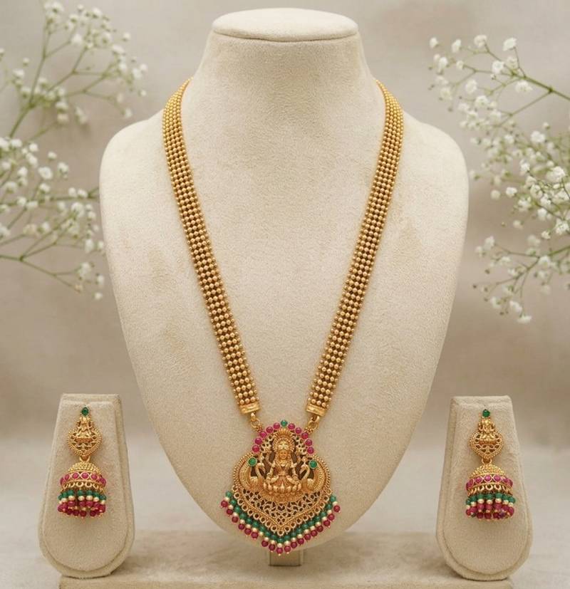 gold temple jewelry set with goddess lakshmi pendant, green & red beads & jhumkas 