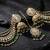 gold plated kundan & mirror work green  jhumka earrings with ear chain 