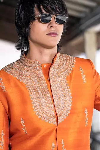 Saffron orange embroidered raw silk sherwani set