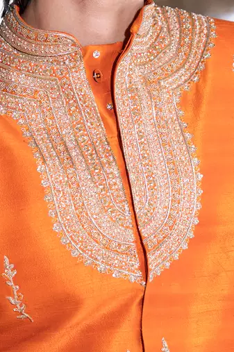 Saffron orange embroidered raw silk sherwani set