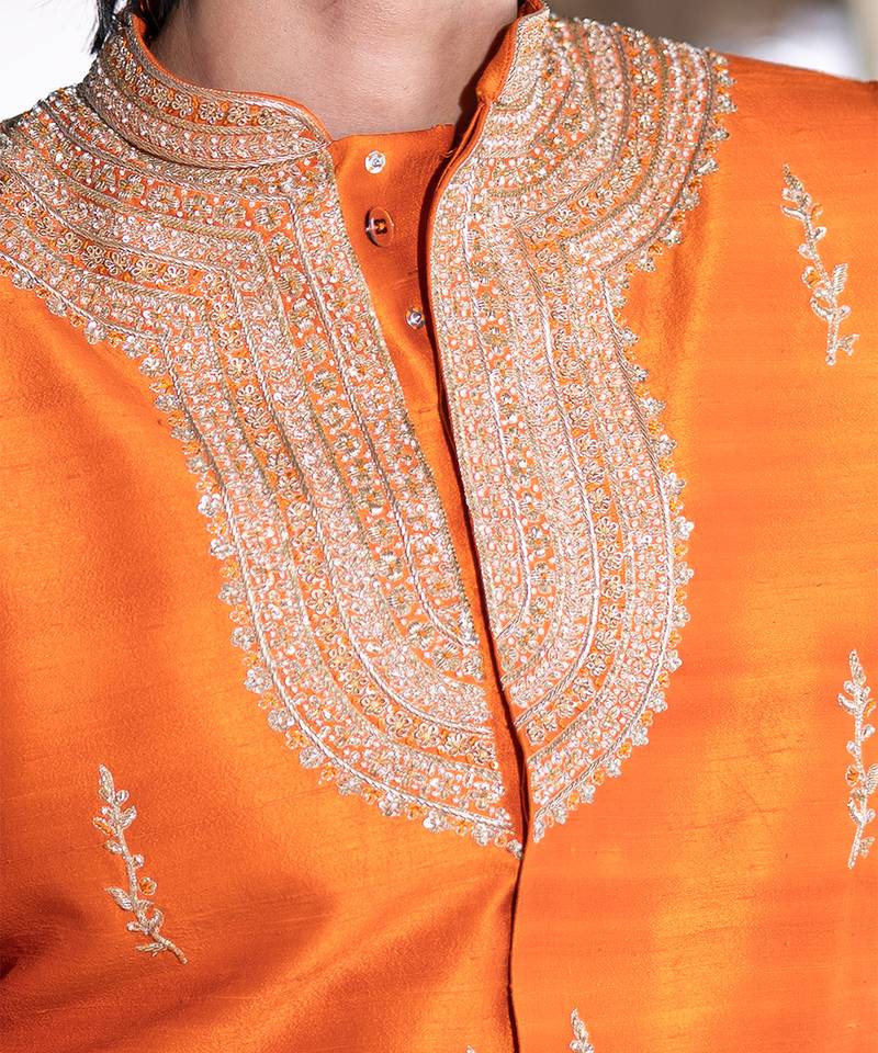 Saffron orange embroidered raw silk sherwani set