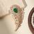 Gold plated green stone american diamond leaf brooch