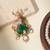 Gold plated green stone kundan dear motif brooch