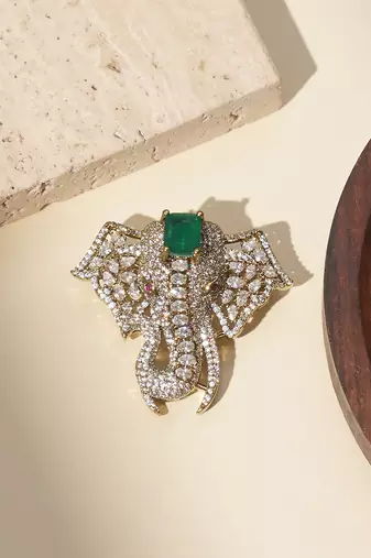 Gold plated green stone american diamond brooch