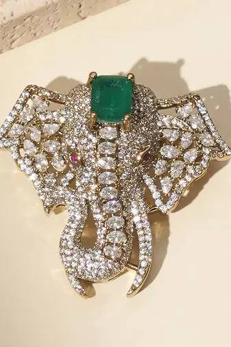 Gold plated green stone american diamond brooch