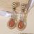 Gold plated peach stone kundan long earrings