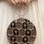 Black multipattern thread embroidery round clutch