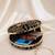 Black multipattern thread embroidery round clutch