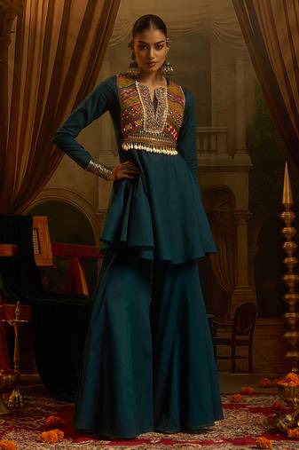Teal blue mul cotton set with a long-sleeve flared peplum top, mirror-work embroidered yoke.