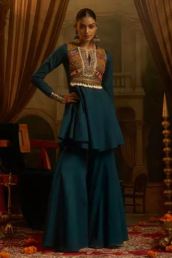 Teal blue mul cotton set with a long-sleeve flared peplum top, mirror-work embroidered yoke.