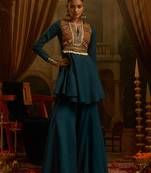 Teal blue mul cotton set with a long-sleeve flared peplum top, mirror-work embroidered yoke.
