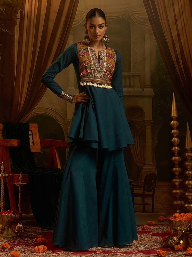 Teal blue mul cotton set with a long-sleeve flared peplum top, mirror-work embroidered yoke.