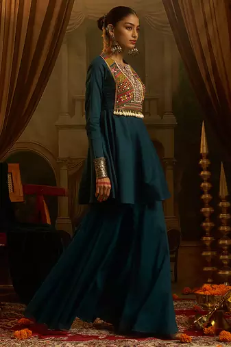 Teal blue mul cotton set with a long-sleeve flared peplum top, mirror-work embroidered yoke.