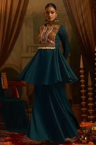 Teal blue mul cotton set with a long-sleeve flared peplum top, mirror-work embroidered yoke.