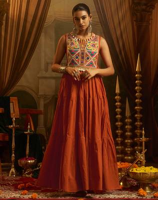 Elevate festive style with this rust orange gown featuring intricate mirror and thread embroidery. 1