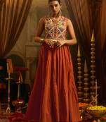 Elevate festive style with this rust orange gown featuring intricate mirror and thread embroidery.