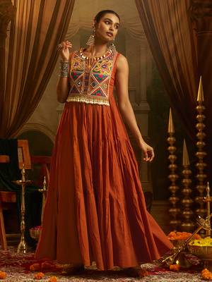 Elevate festive style with this rust orange gown featuring intricate mirror and thread embroidery. 2