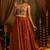 Elevate festive style with this rust orange gown featuring intricate mirror and thread embroidery.