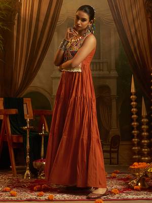 Elevate festive style with this rust orange gown featuring intricate mirror and thread embroidery. 3