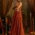 Elevate festive style with this rust orange gown featuring intricate mirror and thread embroidery.