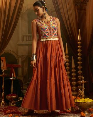 Elevate festive style with this rust orange gown featuring intricate mirror and thread embroidery. 4