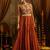 Elevate festive style with this rust orange gown featuring intricate mirror and thread embroidery.