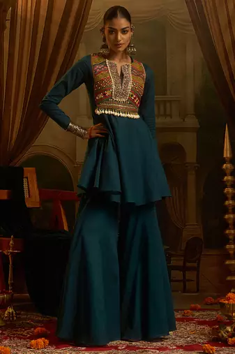 Teal blue mul cotton set with a long-sleeve flared peplum top, mirror-work embroidered yoke.